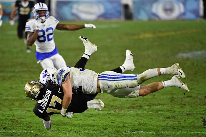 Dec 22, 2020; Boca Raton, Florida, USA; Brigham Young Cougars linebacker Max Tooley (31) tackles UCF Knights wide receiver Amari Johnson (17) on the punt return during the second half at FAU Stadium. Mandatory Credit: Jasen Vinlove-USA TODAY Sports